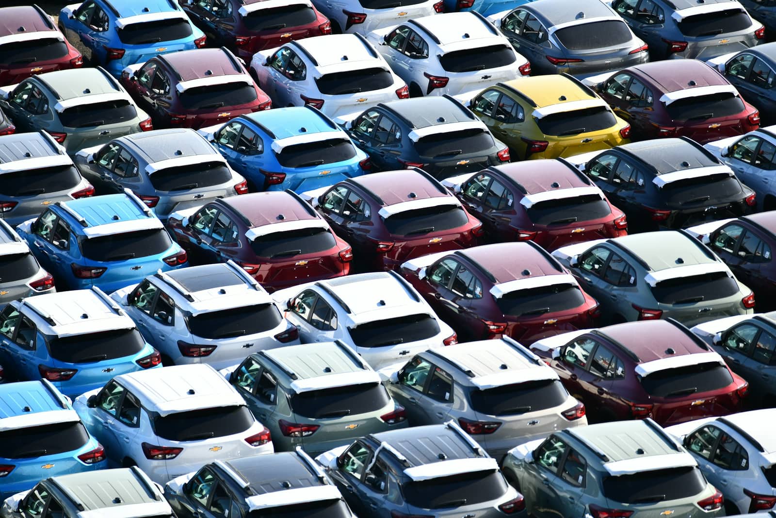 Rows of used vehicles parked on a dealership lot.